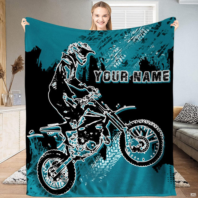Motocross rider graphic bedding set with teal splatters and tire tracks on black.