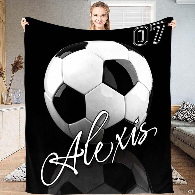 Monochrome soccer ball athletic number art blanket held up by woman
