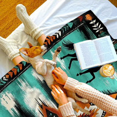 Southwestern bedding set styled in a rustic bedroom featuring black horse silhouettes and turquoise geometric motifs.