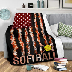 Sports graphic piece draped across gray sectional couch beside coffee cup and book stack.