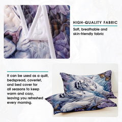 Folded bedding arrangement displaying floral white tiger art and muted icy-blue tones.