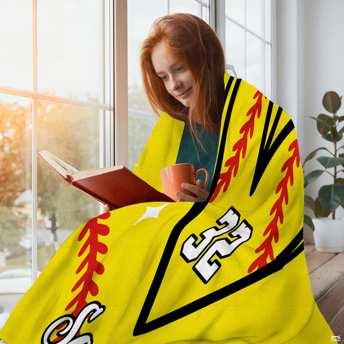 Draped perspective of softball heart throw blanket highlighting optic yellow color and sparkles.