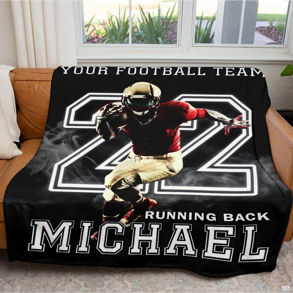 Folded athletic blanket highlighting gold helmet and crimson jersey artwork