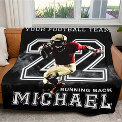 Folded athletic blanket highlighting gold helmet and crimson jersey artwork