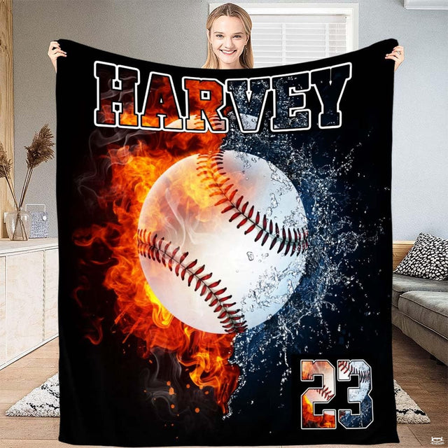Baseball blanket displaying split fire and water artwork arranged flat across bedroom bedding.