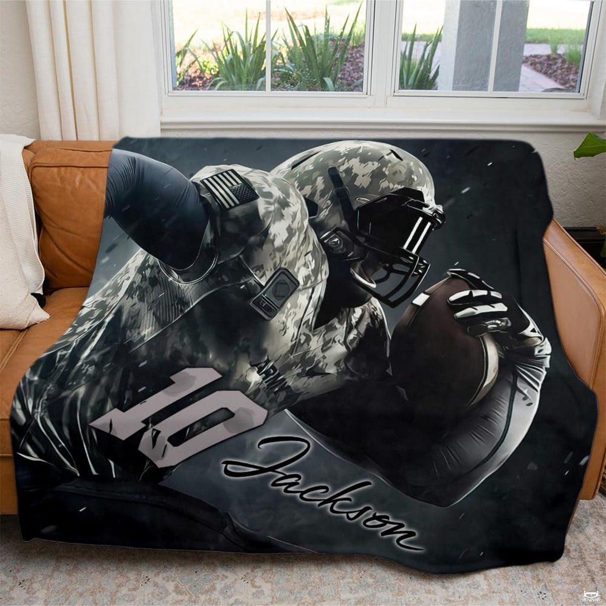 Camo football sports throw blanket draped across brown leather living room sofa