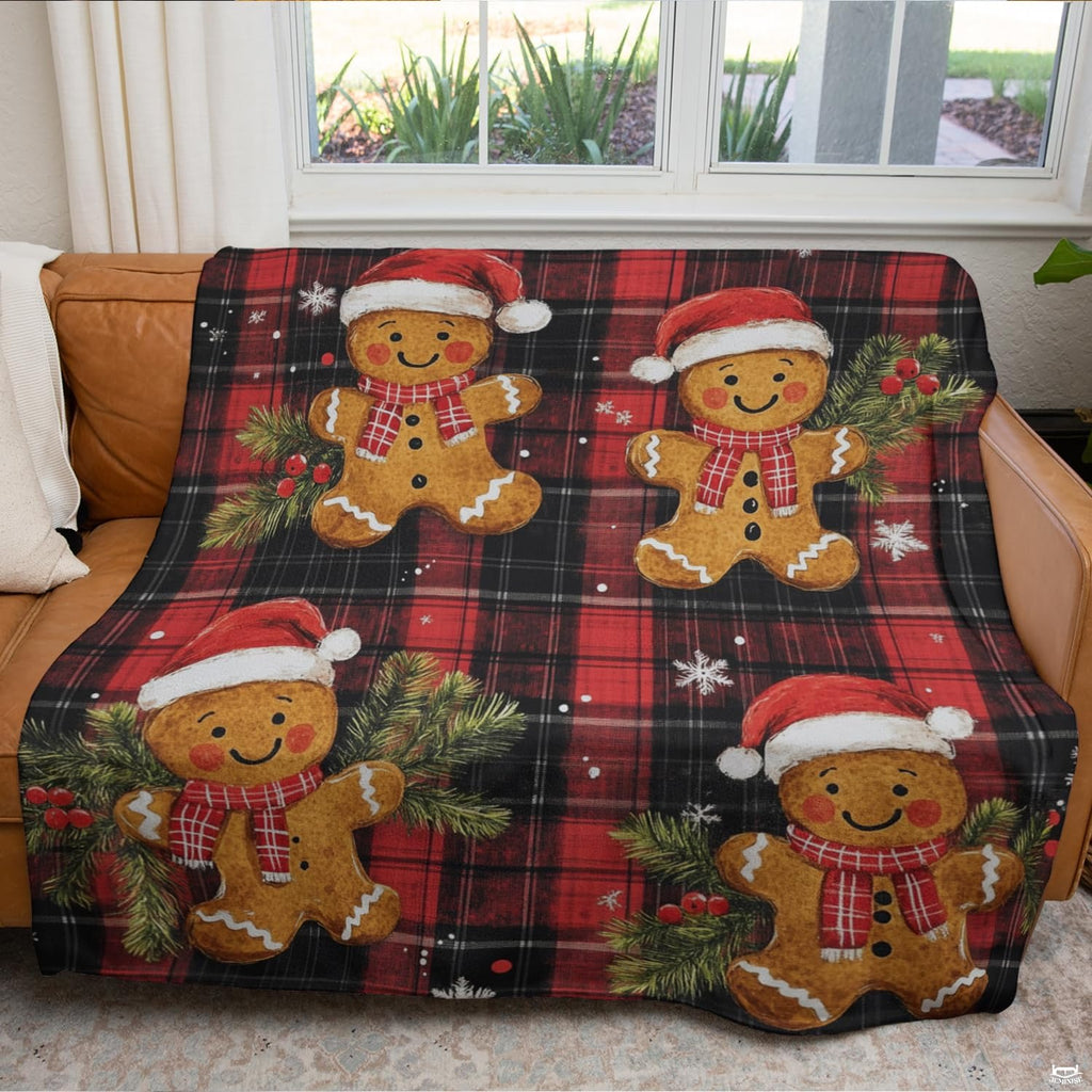 Top view of red and black buffalo plaid bedding print with smiling holiday gingerbread figures.