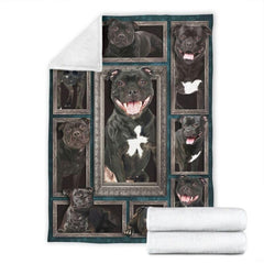 Folded corner and rolled layout of the Staffordshire Bull Terrier blanket showing the white reverse side.