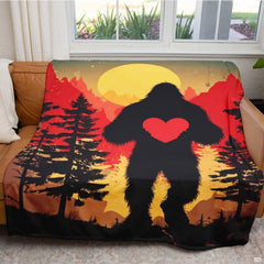 Bigfoot holding heart throw blanket view 5 highlighting Sasquatch silhouette, scarlet heart, and sunset sky