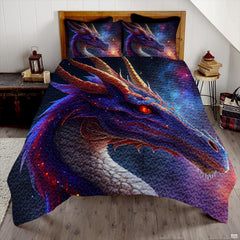 Indigo dragon with copper horns and glowing orange eye displayed on a bed