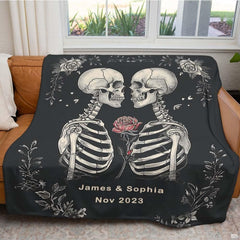 Cozy lifestyle setting with gothic skull lovers design draped on bed.