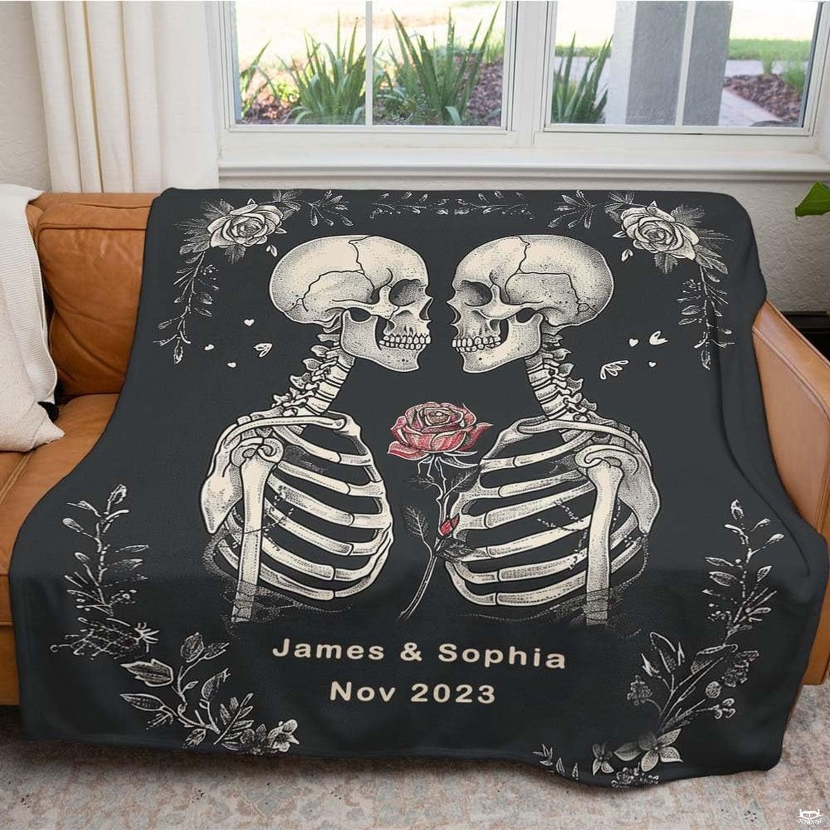 Cozy lifestyle setting with gothic skull lovers design draped on bed.