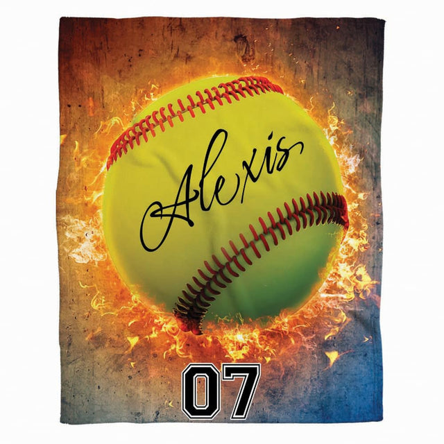 Front full view of flaming softball blanket featuring vibrant neon yellow ball surrounded by blazing orange fire