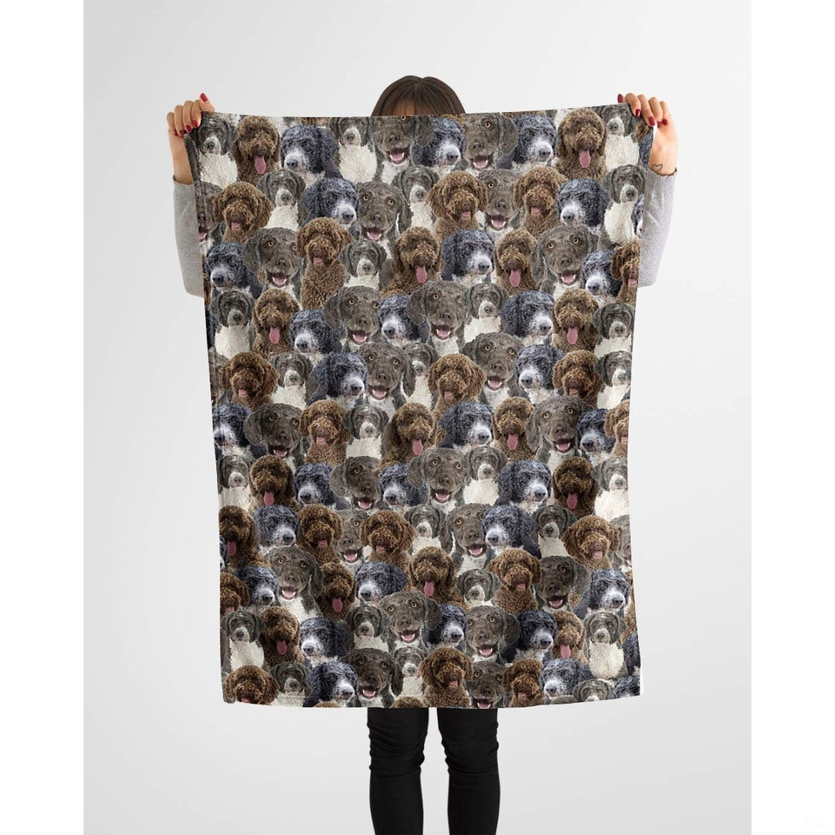 Person holding up a repeating Spanish curly retriever blanket against a plain background.