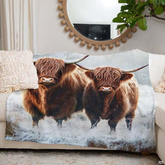 Close-up visual detail of horned cattle illustration on scenic scottish highland bedding.