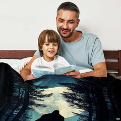 Adult and child reading a story together beneath the night forest Bigfoot print in an indoor setting.