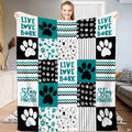 Teal dog paw print patchwork throw blanket with bold puppy paws and chevron zigzag blocks