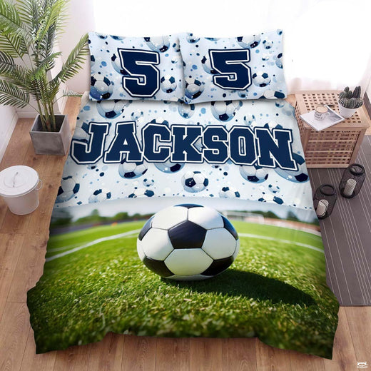 Pastel sky blue and sage soccer sports bedding featuring a soccer ball graphic with blue arcs on a bed