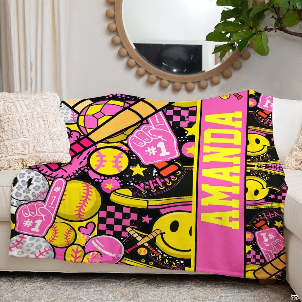 Detail perspective of pink catching mitt and leopard softball on sports throw blanket.