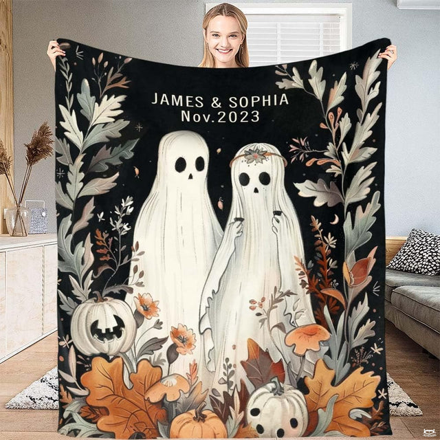 Close-up of ghost illustration wearing floral headband with pumpkins on fall halloween bedding.