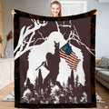 Patriotic Bigfoot blanket held open displaying the American flag Sasquatch graphic and camo border.