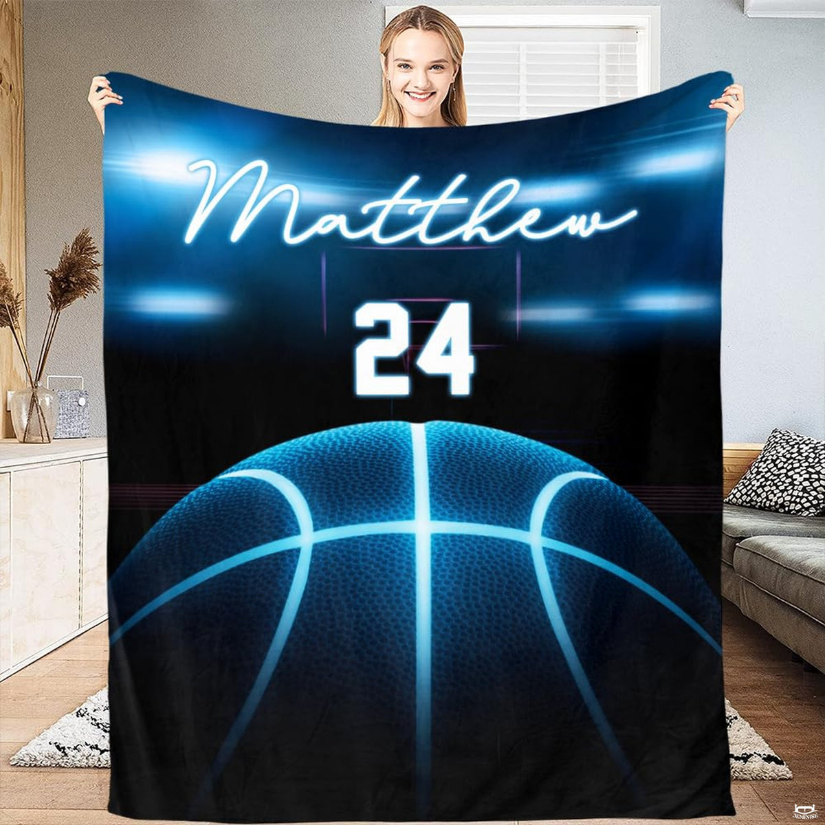 Woman holding open neon blue basketball sports throw blanket in modern room
