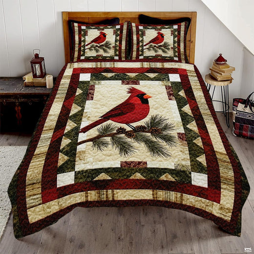 Vintage winter cardinal red bird patchwork bedding set displayed neatly on a bed in a rustic bedroom