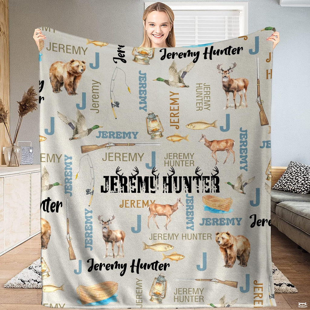 Draped rustic throw blanket showing bears and deer pattern over a neutral living room sofa