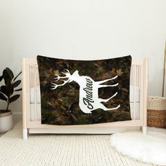 Rustic hunter bedding set displayed across a wooden lodge bed against thematic accent cabin bedroom walls