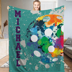 Close-up view of vibrant ink drips and paint splash details on an athletic bedroom theme.