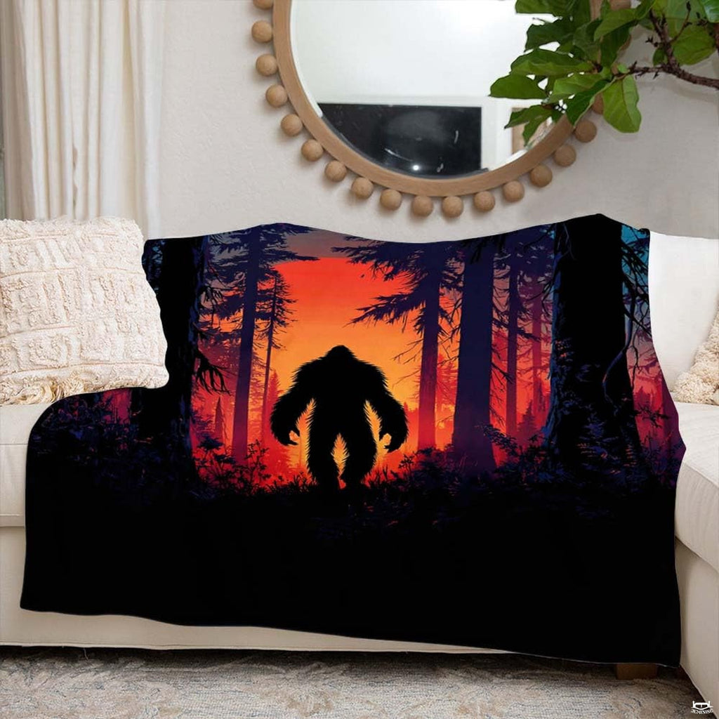 Sunset Bigfoot throw blanket view 6 highlighting fiery amber sunset and pine timber silhouettes