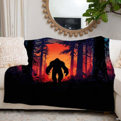 Sunset Bigfoot throw blanket view 6 highlighting fiery amber sunset and pine timber silhouettes