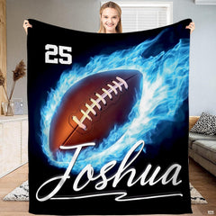 American football engulfed in vibrant blue burning flames on a deep black background for modern minimalist bed set decor.