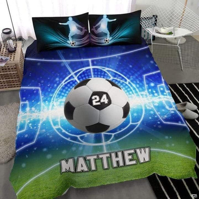 Royal blue and ice cyan soccer cleats sports bedding featuring athletic soccer shoes and a ball on a bed
