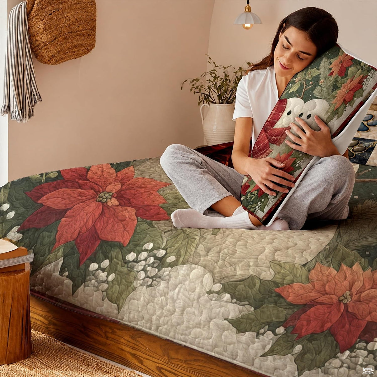 Detailed view of botanical winter pine foliage and red poinsettia motif on holiday bedding.