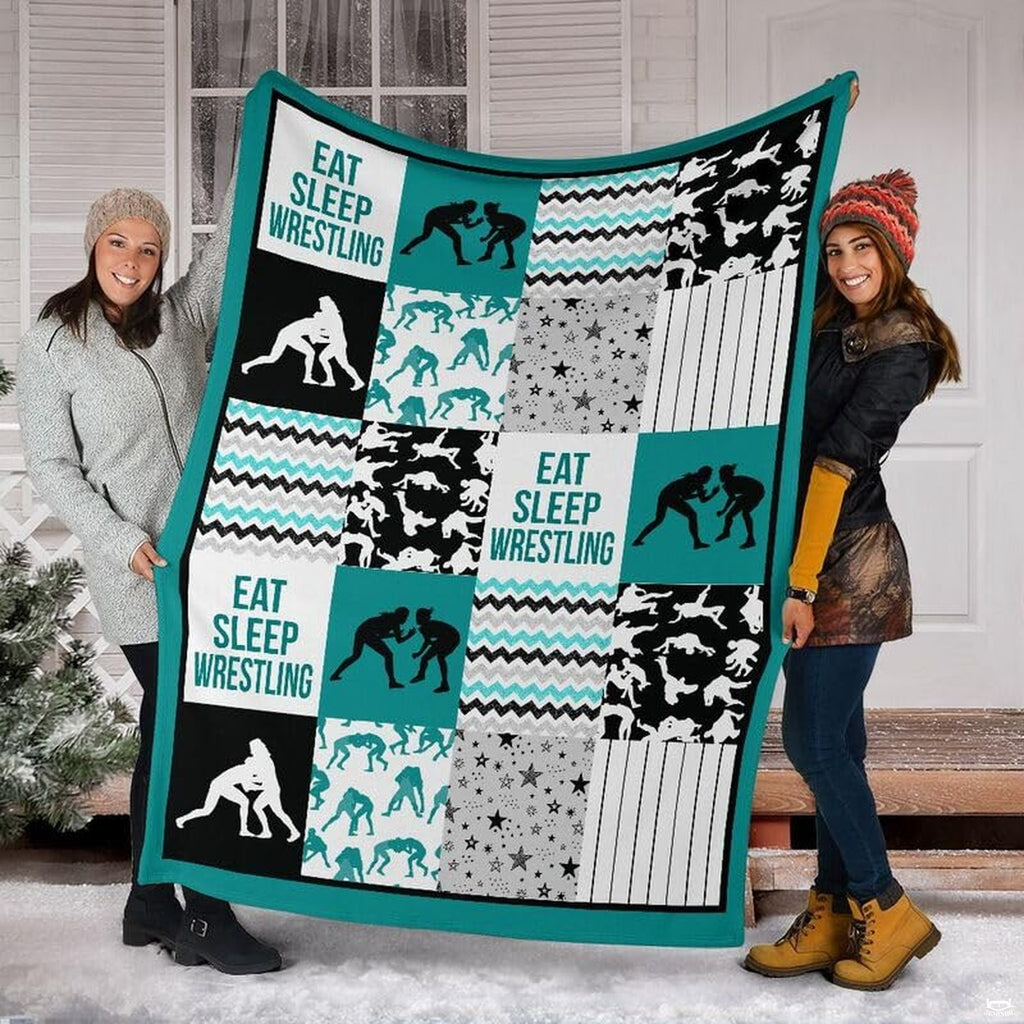 Detail view of neat hemmed edge and high-contrast printing on teal wrestling blanket.