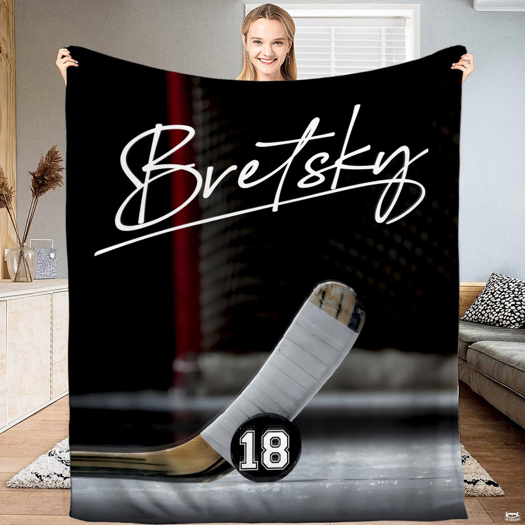 Ice hockey stick blade and puck goal crease blanket held upright