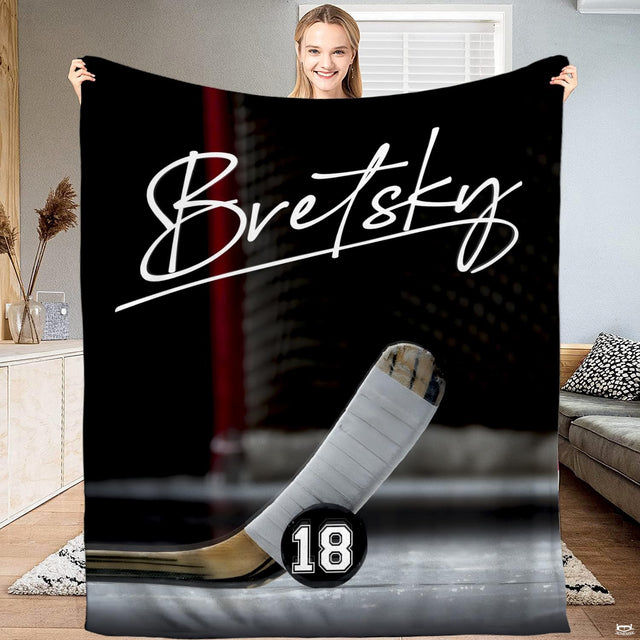 Ice hockey stick blade and puck goal crease blanket held upright