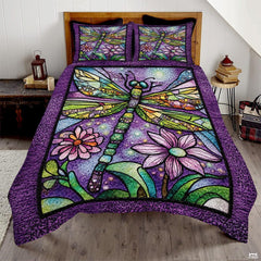 Stained glass dragonfly purple floral bedding set spread flat on a wooden bed with matching shams.