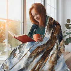 Person reading beside window wrapped in winter Sasquatch and caught trout graphic.