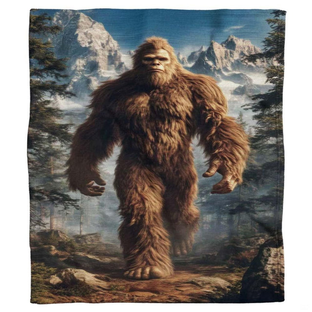 Detailed Sasquatch motif surrounded by evergreen pine trees and snowy mountain horizons.