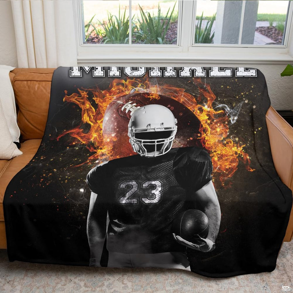 Atmospheric game day fan cave couch display featuring fiery flaming football throw blanket