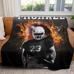Atmospheric game day fan cave couch display featuring fiery flaming football throw blanket