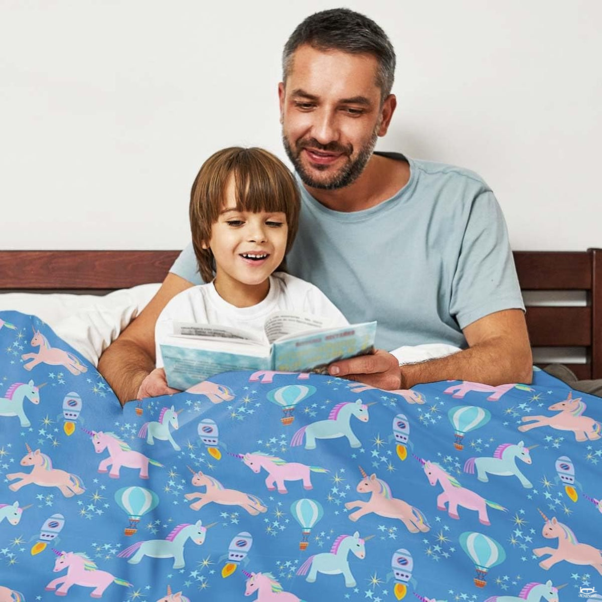 thematic accent perspective of bedroom featuring vibrant royal blue bedding set with magical pastel unicorn pattern.