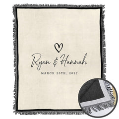 Folded minimalist couple throw blanket showing decorative fringe edges and crisp black graphic printing