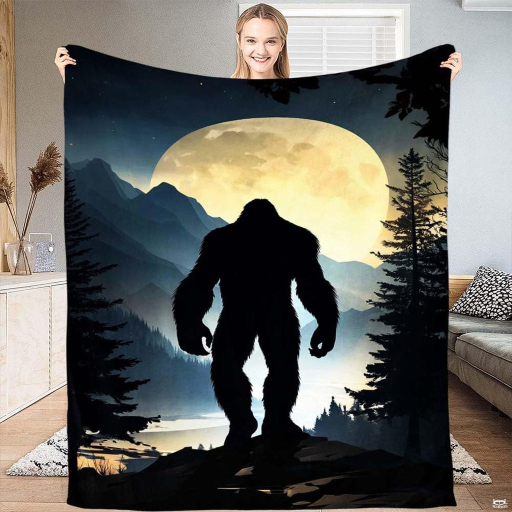Bigfoot silhouette walking beneath a glowing thematic accent moon over mountain lodge bedding pine scenery.