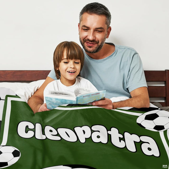 Living room sofa setting displaying the green soccer crest sports throw blanket draped on furniture.