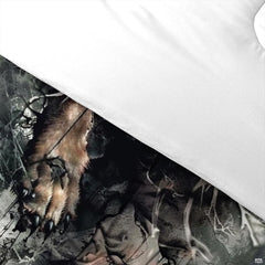 Detail of wolf forepaw, claws, forest textures, and plain white reverse