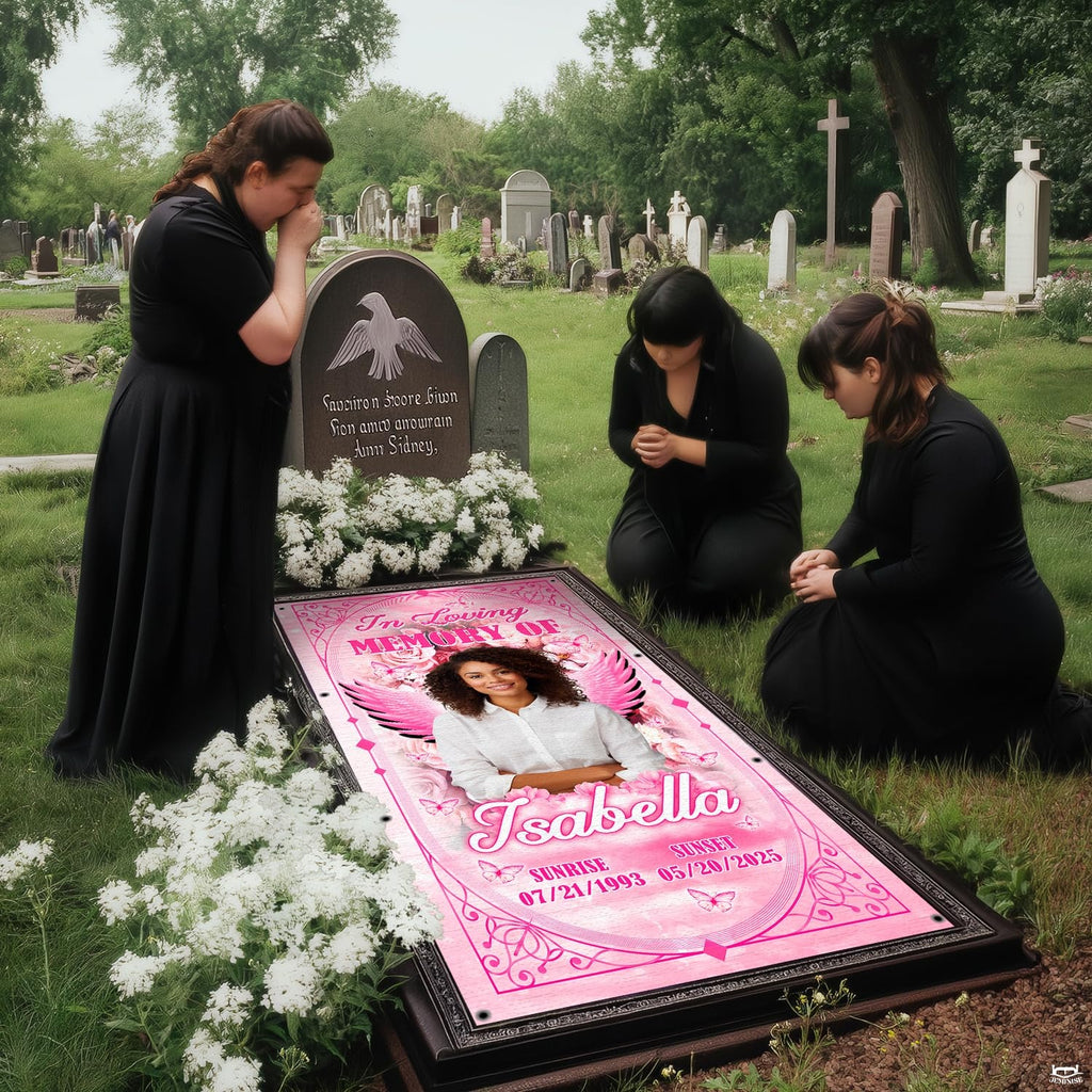 Solemn cemetery setting with mourners in dark attire kneeling beside the pink tribute.