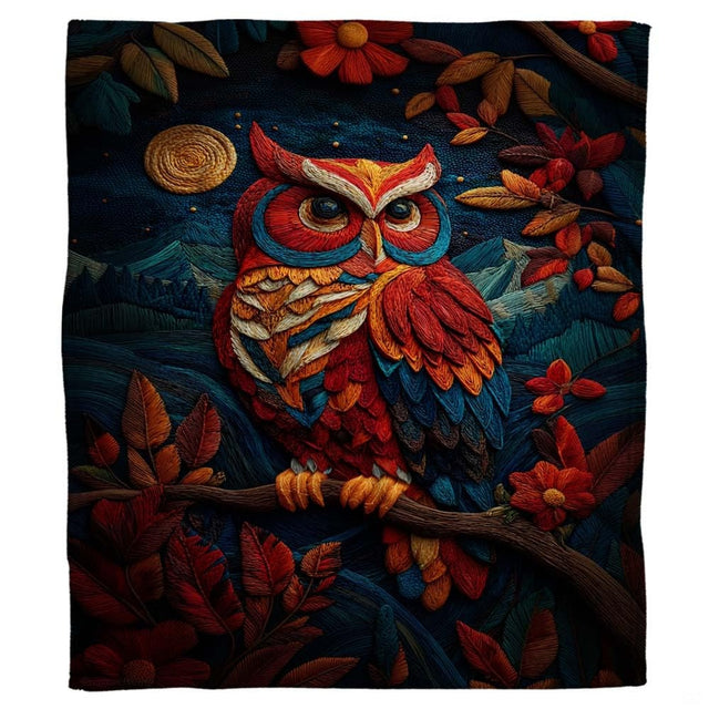 Close-up detail of textured crimson, orange, and blue owl plumage on a blanket